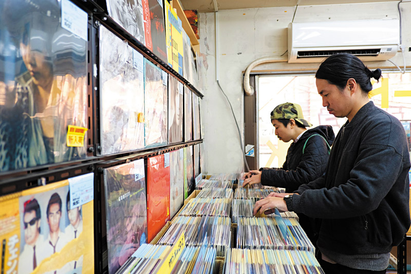 Norio Sato (left) and Eiji Taniguchi dig through records at Sound Pak in Osaka  ROGER BONG PHOTOS 