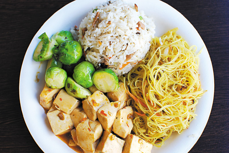Water Drop Vegetarian House lets diners choose two or four side options, in addition to starch. Pictured is the restaurant's version of fried rice and stir-fried noodles, accompanied with mapo tofu and Brussels sprouts