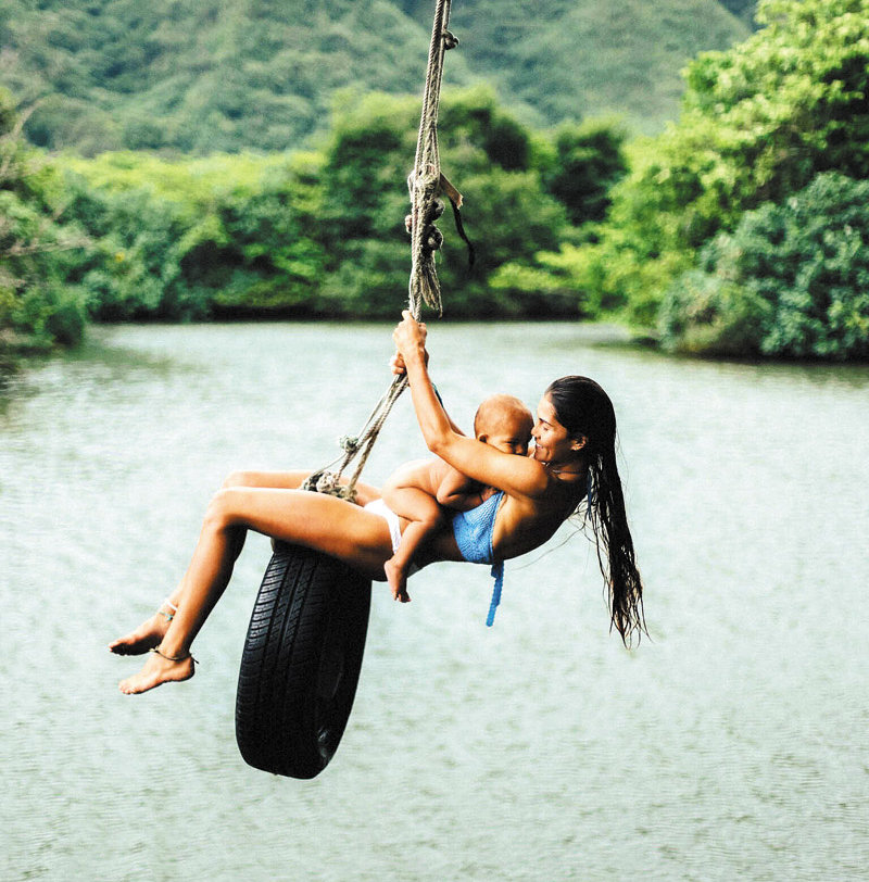 Mona-Jane swinging with her son at Kahana Bay